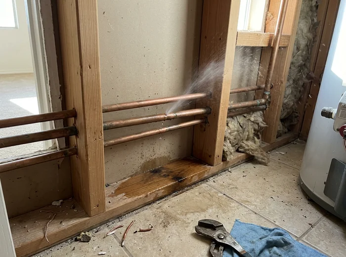 Pinhole leak in a copper supply line inside a wall cavity