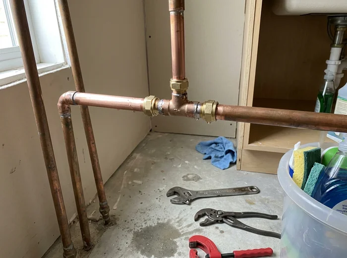 Repaired copper pipe section with new fittings